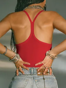 Back view of a red ribbed racerback tank top featuring an open back design for women