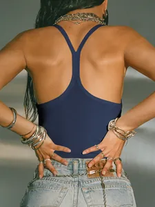 Detailed macro shot of navy blue ribbed backless tank top for women with stylish accessories
