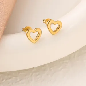 Detailed view of polished gold-colored stainless steel heart-shaped stud earrings.