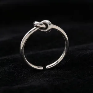 Detailed macro view of a silver titanium steel ring with a stylish knot design element