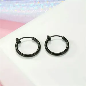 Close-up view of black stainless steel spring hoop clip-on earrings