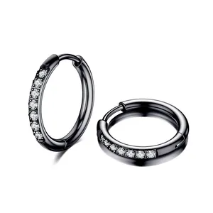 Detailed macro shot of black titanium steel hoop earrings with clear crystal accents