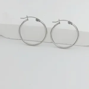 Nahaufnahme minimalistischer 1,5 mm Edelstahl Creolen für Schmuckdetails auf weißem Grund