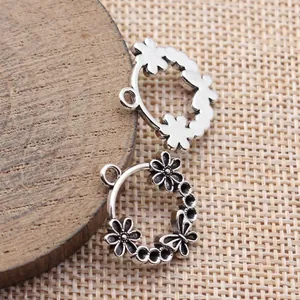 Antique silver alloy charm pendants featuring flower and butterfly motifs for DIY jewelry