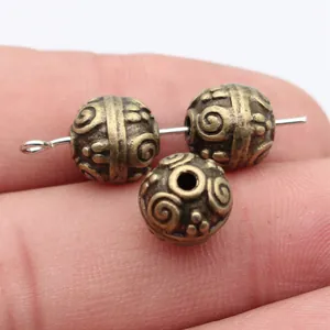 Vintage style 10mm bronze spacer beads with swirl texture for unique jewelry DIY designs