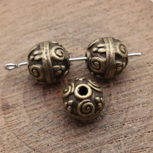 Premium 10mm antique bronze spacer beads featuring an intricate swirl texture pattern
