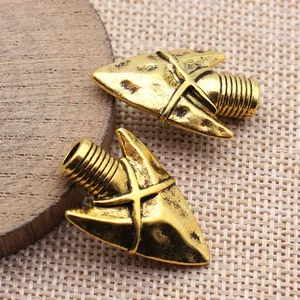 Vintage golden metal arrowhead charms for DIY jewelry making and necklace pendants.