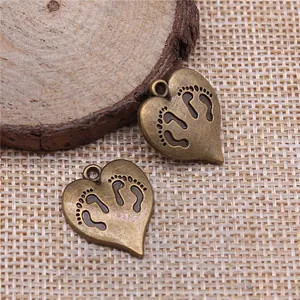 Antique bronze heart-shaped charm with baby footprint engravings for jewelry making