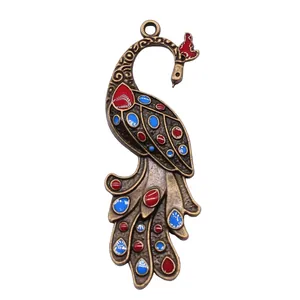 Antique bronze peacock pendant with exquisite red and blue enamel detail, 60x23mm.
