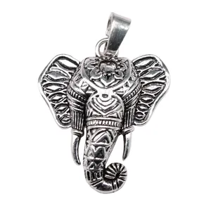 Retro antique silver elephant head pendant with detailed tribal ethnic carvings