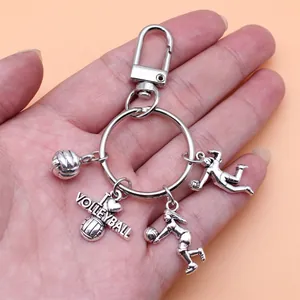 Detailed silver-toned volleyball keychain with unique charms and heart engraving