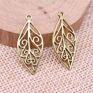 Two vintage golden hollow leaf charms pendants for DIY jewelry making accessories