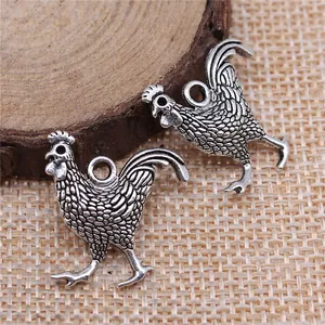 Antique silver rooster charms 24x22mm for DIY jewelry making on rustic background