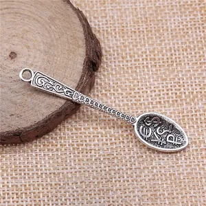 Vintage silver spoon charm pendant with engraved currency symbols