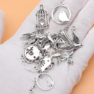 27pcs antique silver bird charms set featuring swallows and birdcages for DIY jewelry making