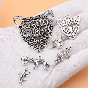 Set of 7 antique silver leopard charms for jewelry making, 28g total