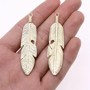Golden alloy feather pendant charms for DIY jewelry making, 62x15mm size.