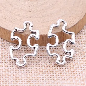 Two antique silver-toned puzzle piece charms for handmade DIY jewelry craft projects