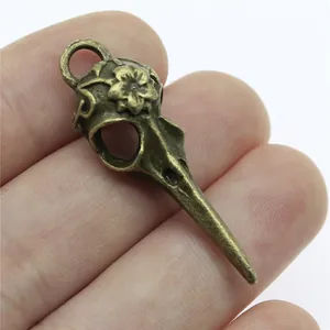 Vintage bronze bird skull pendant with flower detail for DIY jewelry making