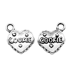 Pair of antique silver heart-shaped cookie pendants with 'COOKIE' engraved detail
