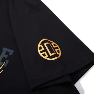 Close-up detail of a black streetwear plus size T-shirt with a golden sleeve print