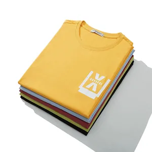 Stack of colorful oversized cotton T-shirts with white graphic print on top yellow shirt