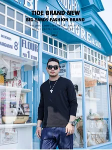Asian man in a black plus-size long-sleeve crew neck T-shirt on a city street