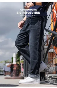 Detailed side view of men's black straight-leg jeans in a casual outdoor setting