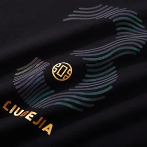 Detail view of black streetwear T-shirt featuring gold foil LIUGEJIA print and reflective waves