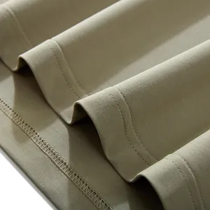Close-up of solid olive green men's casual T-shirt fabric with high-quality stitching.