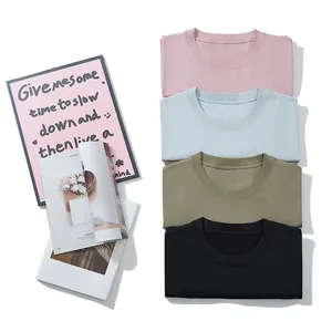 Set of four solid color crewneck cotton T-shirts in various pastel and neutral tones.