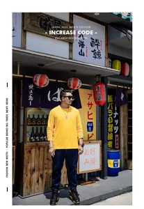Men's large size long-sleeve yellow cotton T-shirt in urban Japanese street setting