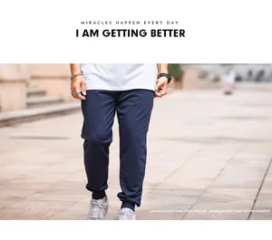 Detail showing navy blue plus size joggers with elastic waist and cuffed ankles.