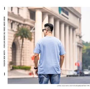 Macro view of the back of a light blue plus size loose fit cotton T-shirt for men