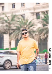 Outdoor detail shot of a loose-fitting yellow short-sleeved T-shirt for men