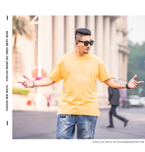 Detailed view of a men's oversized solid yellow T-shirt with a relaxed fit for summer wear