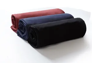 Close-up of rolled fabric showing black, navy, and burgundy casual sweatpants texture