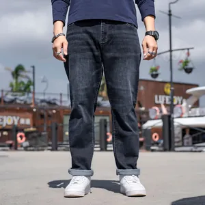 Premium black business casual straight leg denim jeans for men with a cuffed hem