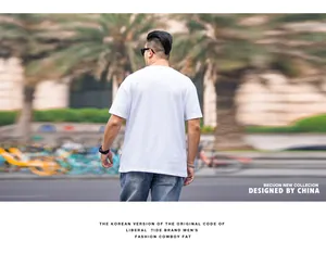 Back view of a man in a loose white dropped shoulder t-shirt for summer fashion