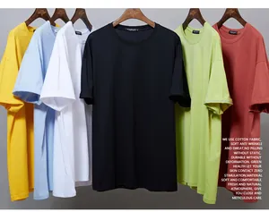 Detail view of six colorful oversized men's cotton T-shirts hanging on hangers