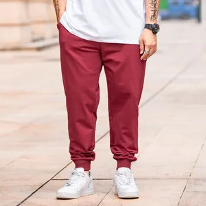 Men's maroon plus size jogger pants with elastic waist and cuffed ankles for casual sports
