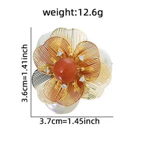 Elegant baroque pearl flower brooch featuring a red natural stone and gold wire detailing