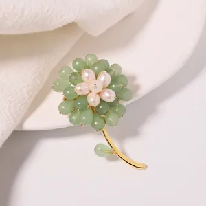 Close-up of handmade sunflower brooch with green aventurine beads and white pearls
