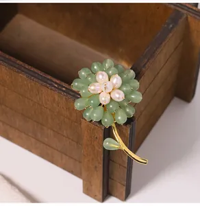 Macro detail of sunflower brooch featuring aventurine jade and freshwater pearls