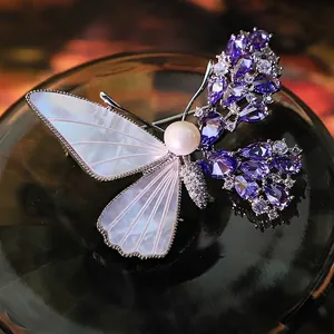 Handcrafted vintage butterfly brooch with natural pearl shell and shimmering purple zircon