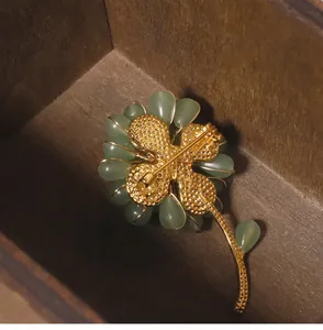 High-quality back detail of handmade sunflower brooch featuring green Dongling jade stones