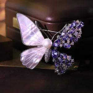 Elegant butterfly brooch crafted with natural pearl shell and sparkling purple zircons.