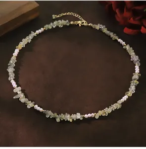 Detailed view of handmade necklace with natural freshwater pearls and grape crystal stones