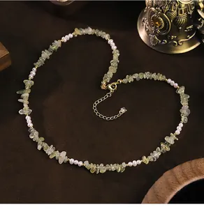Close-up of natural freshwater pearl and prehnite chip stone necklace with gold chain