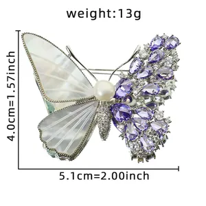 Elegant butterfly brooch featuring natural shell wings and sparkling purple zircons
